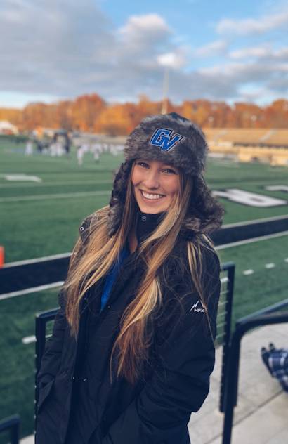 Student smiling in photo while at GVSU football game